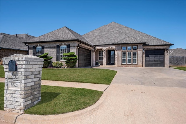 8521 NW 124th St, Oklahoma City, OK 73142 - french country inspired facade featuring brick siding, a garage, and concrete driveway