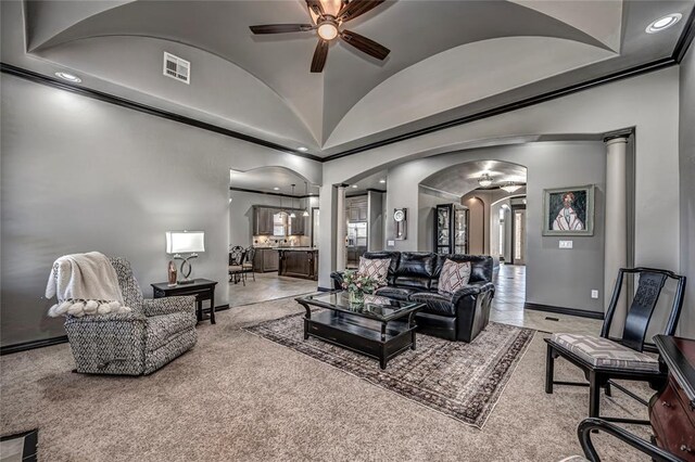8521 NW 124th St, Oklahoma City, OK 73142 - living room featuring arched walkways, ceiling fan, light colored carpet, vaulted ceiling, and baseboards