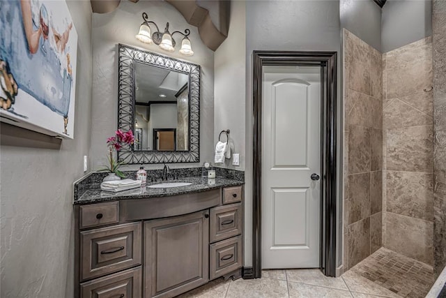 8521 NW 124th St, Oklahoma City, OK 73142 - bathroom with vanity, a textured wall, tile patterned flooring, and a tile shower