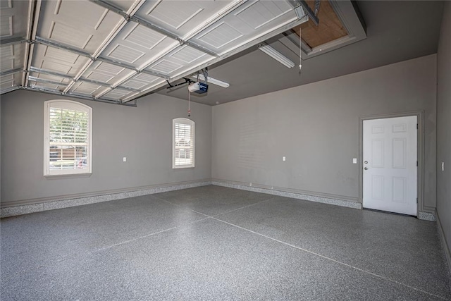 8521 NW 124th St, Oklahoma City, OK 73142 - garage with a garage door opener and baseboards