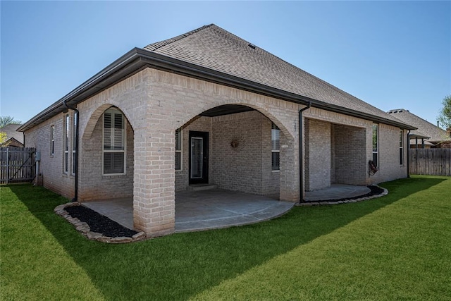8521 NW 124th St, Oklahoma City, OK 73142 - rear view of property featuring a patio area, brick siding, and a shingled roof