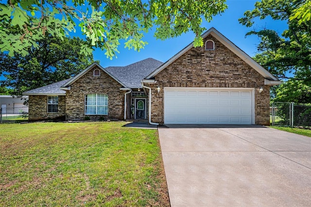 ranch-style home with a front yard, a garage, brick siding, fence, and concrete driveway