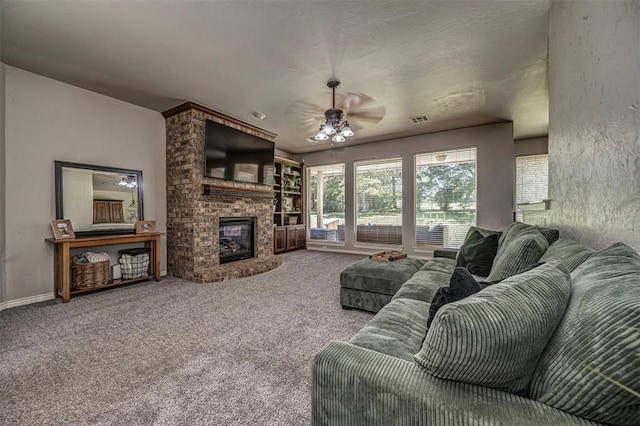 carpeted living area with visible vents, ceiling fan, and a fireplace