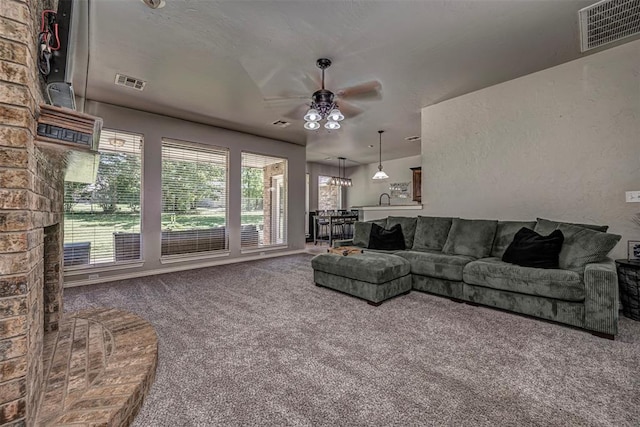 living room with carpet flooring, a ceiling fan, and visible vents