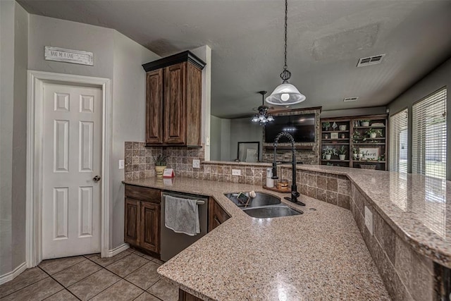 kitchen with visible vents, light tile patterned flooring, a sink, dishwasher, and hanging light fixtures