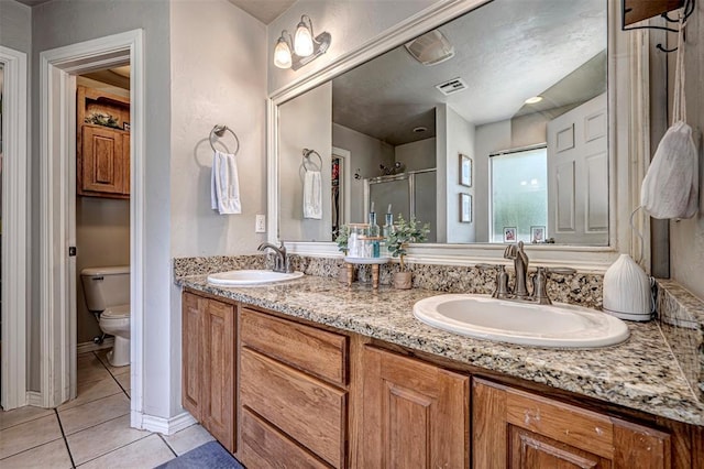 full bathroom featuring tile patterned flooring, a sink, a stall shower, and toilet