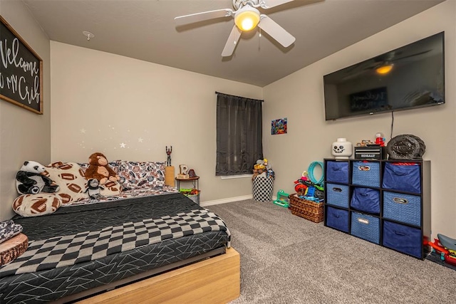 carpeted bedroom featuring baseboards and a ceiling fan