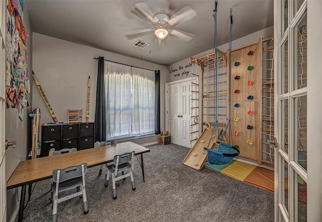 office area with carpet flooring, a ceiling fan, and visible vents