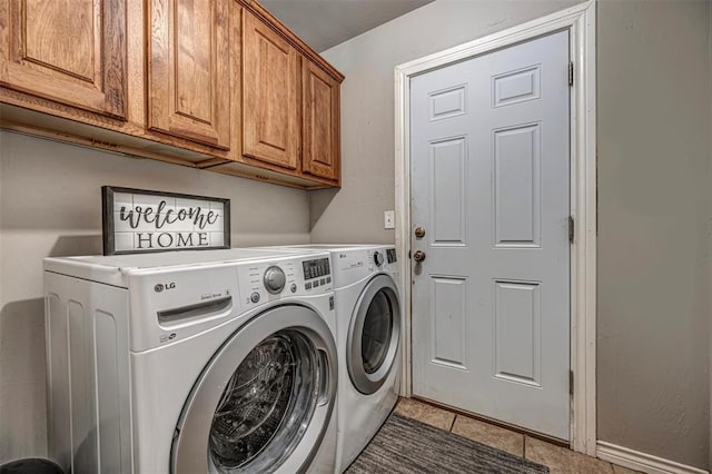 washroom with separate washer and dryer, cabinet space, and tile patterned floors
