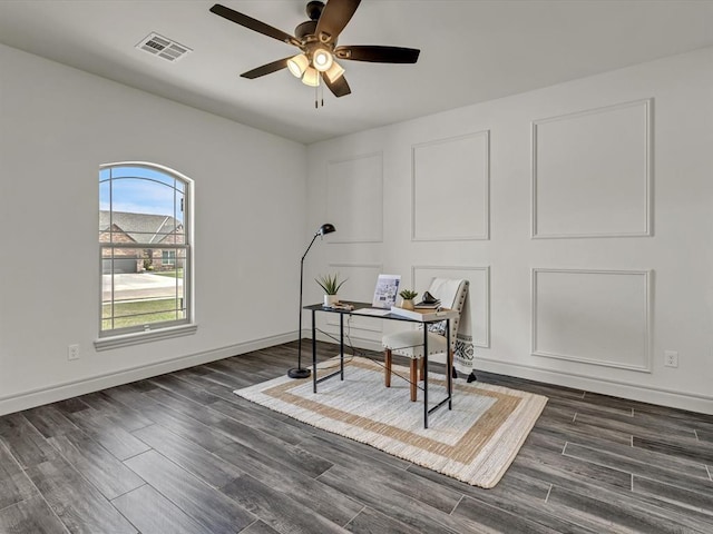 office space with ceiling fan, dark wood finished floors, and visible vents