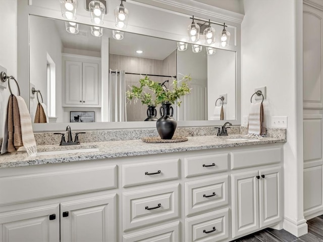 full bath featuring double vanity and a sink