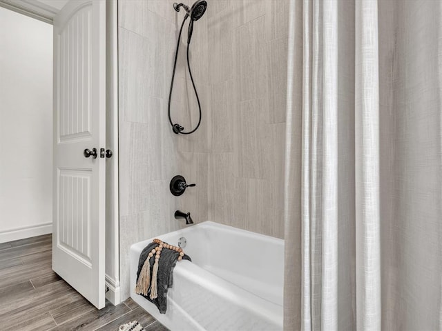bathroom with wood finished floors and shower / tub combo