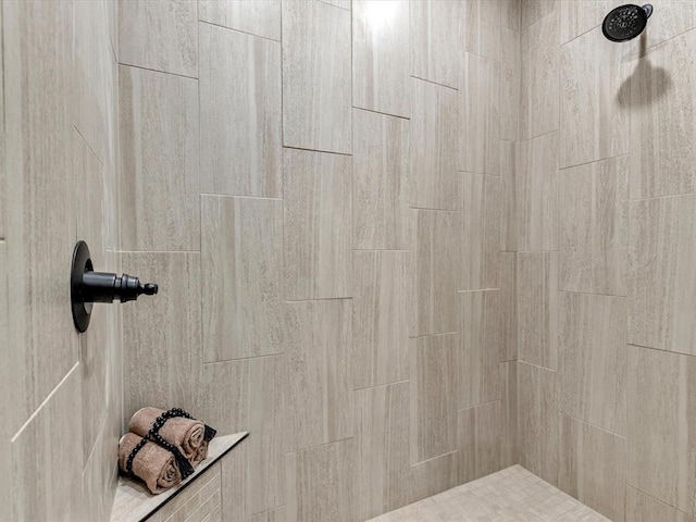 interior details featuring a tile shower