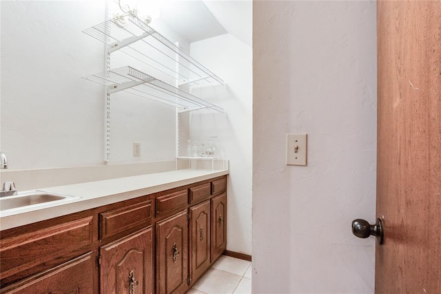 interior space featuring tile patterned floors, vaulted ceiling, and vanity