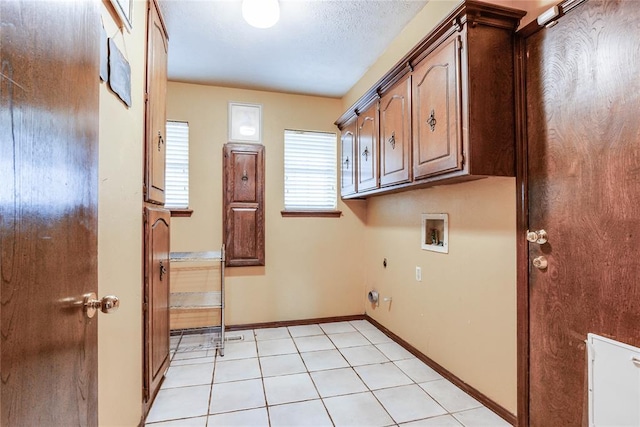 washroom with cabinet space, electric dryer hookup, baseboards, and hookup for a washing machine