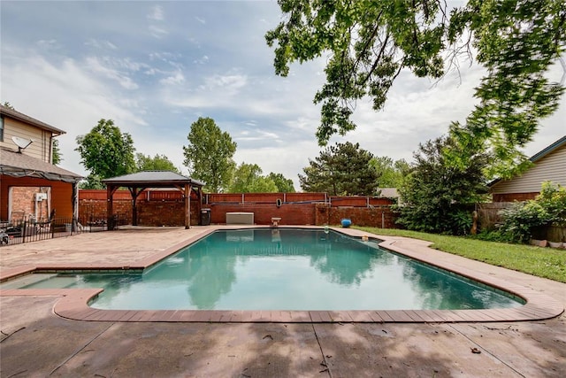 view of pool featuring a fenced backyard, a fenced in pool, a patio, and a gazebo