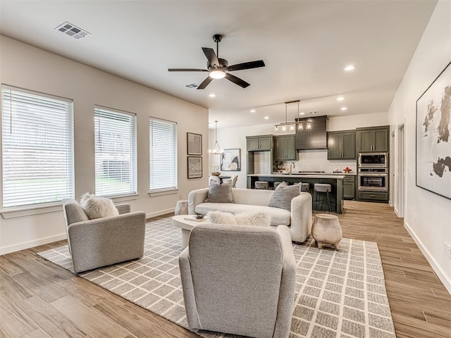 living area with visible vents, recessed lighting, baseboards, and light wood finished floors