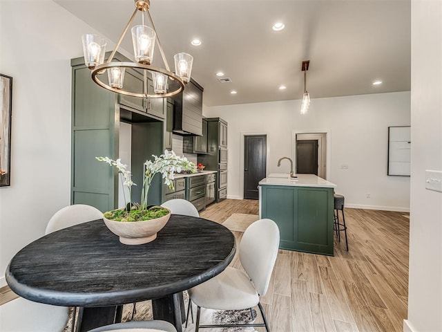 dining space with an inviting chandelier, light wood finished floors, recessed lighting, baseboards, and visible vents