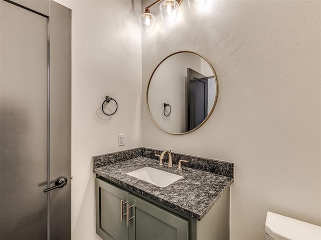 bathroom with toilet and vanity