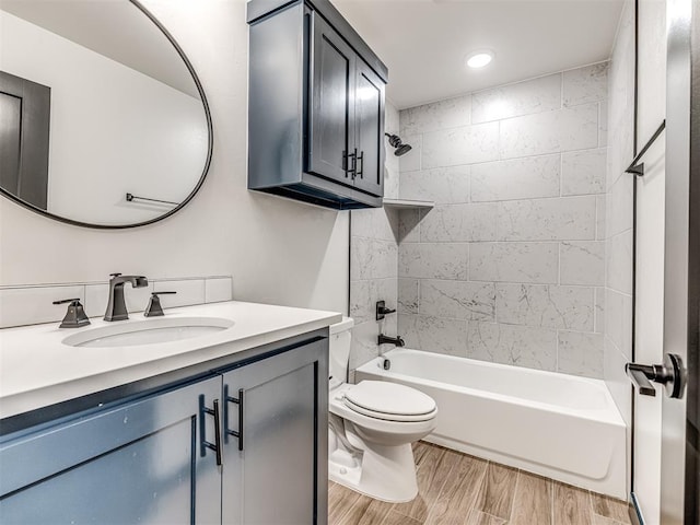 full bathroom featuring vanity, wood finished floors, toilet, washtub / shower combination, and recessed lighting