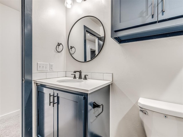 half bath featuring vanity and toilet