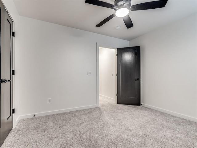 unfurnished bedroom featuring carpet floors, baseboards, and ceiling fan