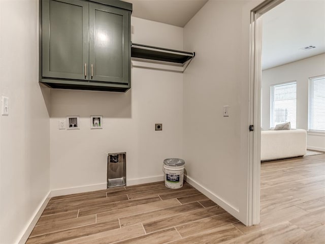 washroom with electric dryer hookup, hookup for a washing machine, baseboards, and light wood-type flooring