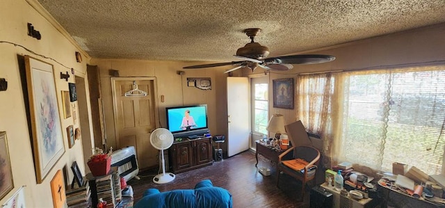 interior space featuring a ceiling fan, a textured ceiling, wood finished floors, and ornamental molding