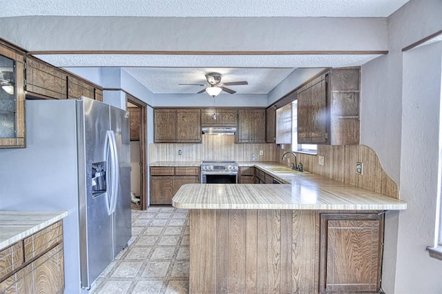204 Sequoia Park Dr, Yukon, OK 73099 - kitchen with a peninsula, a sink, stainless steel appliances, under cabinet range hood, and light countertops