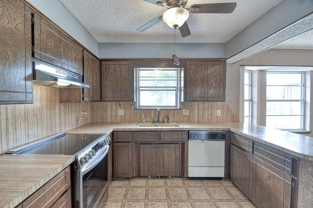 204 Sequoia Park Dr, Yukon, OK 73099 - kitchen featuring a sink, stainless steel range with electric stovetop, a textured ceiling, dishwasher, and under cabinet range hood