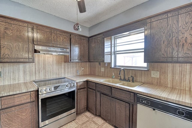 204 Sequoia Park Dr, Yukon, OK 73099 - kitchen featuring under cabinet range hood, a sink, stainless steel electric stove, dishwashing machine, and light countertops