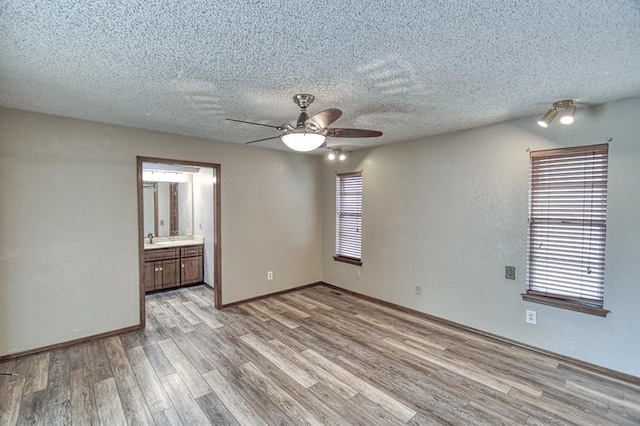 204 Sequoia Park Dr, Yukon, OK 73099 - unfurnished room featuring light wood-type flooring, a textured ceiling, ceiling fan, and a sink