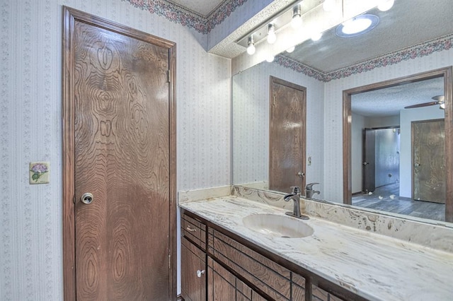 204 Sequoia Park Dr, Yukon, OK 73099 - bathroom with wallpapered walls, a textured ceiling, and vanity