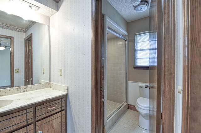 204 Sequoia Park Dr, Yukon, OK 73099 - bathroom featuring toilet, vanity, tile patterned flooring, a shower stall, and wallpapered walls
