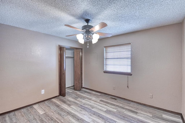 204 Sequoia Park Dr, Yukon, OK 73099 - unfurnished bedroom with baseboards, a closet, light wood finished floors, and visible vents