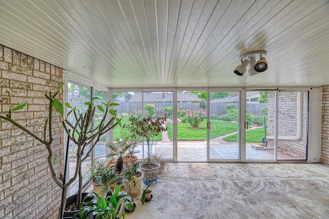 204 Sequoia Park Dr, Yukon, OK 73099 - unfurnished sunroom featuring brick wall and wood ceiling