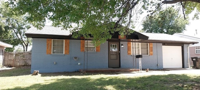 ranch-style home featuring an attached garage and brick siding