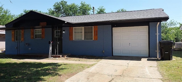 single story home featuring a garage, driveway, brick siding, a front yard, and roof with shingles