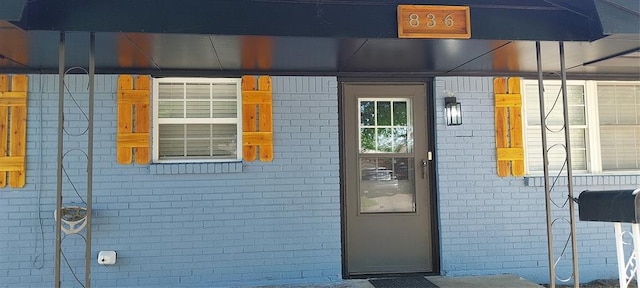 entrance to property with brick siding