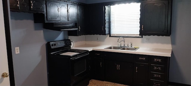 kitchen with black electric range, a sink, dark cabinetry, range hood, and light countertops