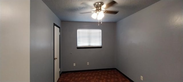 unfurnished room with a ceiling fan, baseboards, and a textured ceiling