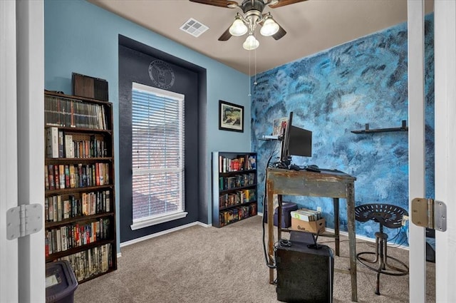 interior space with carpet flooring, ceiling fan, visible vents, and baseboards