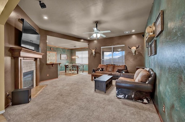 living area featuring carpet floors, baseboards, recessed lighting, a tile fireplace, and a ceiling fan