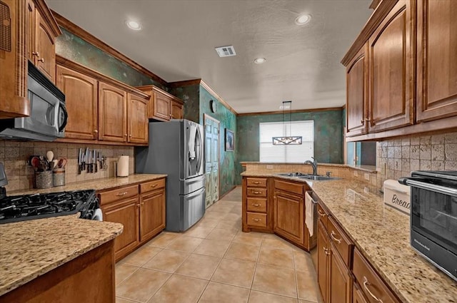 kitchen featuring visible vents, a peninsula, light tile patterned flooring, a sink, and black appliances
