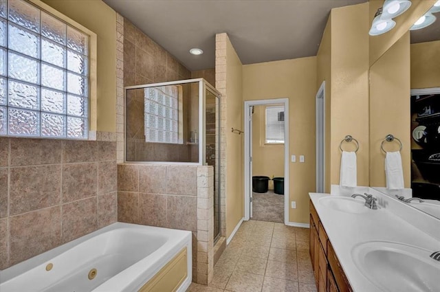 full bath featuring a tub with jets, a sink, tile patterned floors, and a shower stall