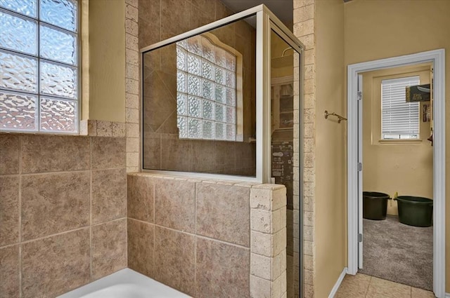 full bathroom with tile patterned floors and a stall shower