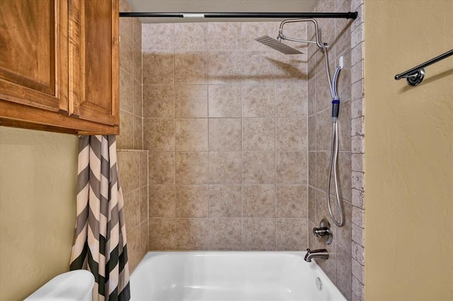 bathroom featuring toilet and shower / bath combination with curtain