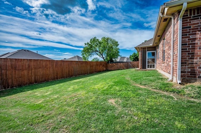 view of yard with a fenced backyard