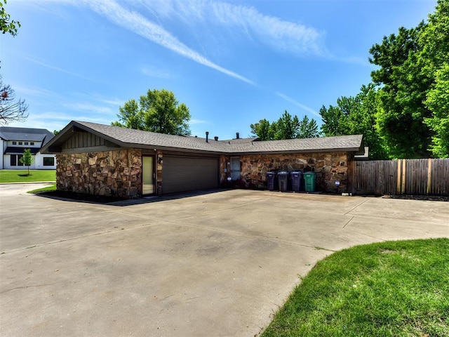 3233 Hickory Stick Rd, Oklahoma City, OK 73120 - view of front facade with stone siding, an attached garage, and driveway