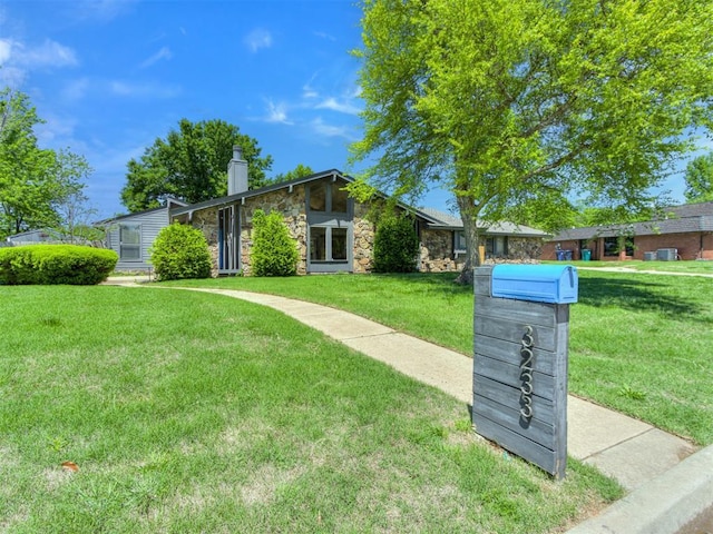 3233 Hickory Stick Rd, Oklahoma City, OK 73120 - mid-century inspired home with stone siding, a chimney, and a front lawn